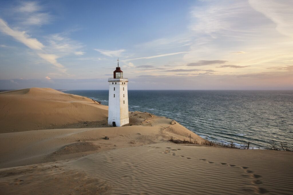 Scenic View Of Lighthouse By Sea Against Sky